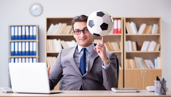 businessman-holding-football
